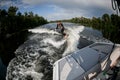 Beautiful view of the river on which along which the man rides on wakesurf. Royalty Free Stock Photo