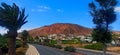 Beautiful view of a road with palms and houses with mountain in the background