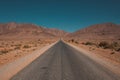 Beautiful view of a road surrounded by deserts and mountains captured in Morocco Royalty Free Stock Photo