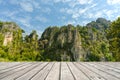 Beautiful view of rock mountain landscape on a sunny day with wooden top table for product display Royalty Free Stock Photo