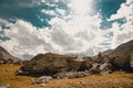 Beautiful view of rocky hills under a sunny cloudy sky in Col de Larche, France Royalty Free Stock Photo