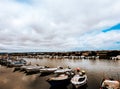 Beautiful view of the rows of fishing boats on the river gleaming under the cloudy sky