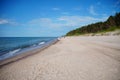 Beautiful view of a sandy beach with forest in the background in Pobierowo, Poland