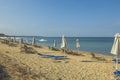 Beautiful view of sandy beach of Mediterranean Sea with people relaxing, sun loungers and umbrellas on. Royalty Free Stock Photo