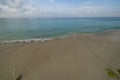 Beautiful view sandy coastline and calm water surface of Atlantic Ocean merging with blue sky on horizon. Royalty Free Stock Photo