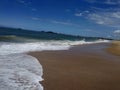 beautiful view of the sea on a deserted beach on a sunny day with a beautiful blue sky with some clouds a lot of sand Royalty Free Stock Photo