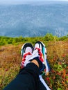 Beautiful view of sea from hills with pair of colorful shoes.