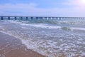 Beautiful view on sea with waves pier coastal city and mountains at sunny day. Royalty Free Stock Photo