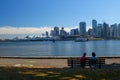 Beautiful view: The Skyline of Vancouver - Couple seating in front on a bench