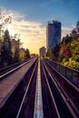 Beautiful view of Skytrain train line Vancouver city saturated with sunset buildings trees beautiful Royalty Free Stock Photo