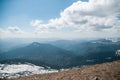 A beautiful view of the snow-capped mountains of the Carpathians from the top of Goverly in spring in a beautiful sunny