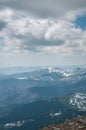 A beautiful view of the snow-capped mountains of the Carpathians from the top of Goverly in spring in a beautiful sunny