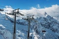 Beautiful view of snowy mountains peaks. Cable car in mountains.Skiers and snowboarders lift to the Ski Resort high in Royalty Free Stock Photo