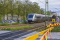 Beautiful view of speed electric train passing crossroad in town. Sweden.