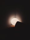 Beautiful view of a spherical light in a corner of a room in the dark
