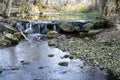 Beautiful view in spring of a waterfall in a small river Royalty Free Stock Photo