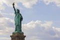 Beautiful view of Statue of Liberty against backdrop of white clouds. New York. Royalty Free Stock Photo