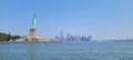 Beautiful view of the Statue of Liberty against the New York cityscape background under a blue sky Royalty Free Stock Photo