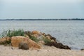 Beautiful view of stones on a sandy beach under the cloudy sky Royalty Free Stock Photo