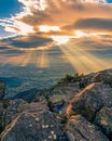 Beautiful view of sun rays from behind the clouds shining over a valley Royalty Free Stock Photo