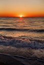 Beautiful view of sunrise in sea. Close Up of waves and beach at sea and colorful sky during sun rise, atmospheric moment. Sunset