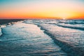 Beautiful view of the sunrise at the wavy ocean captured in Vrouwenpolder, Netherlands