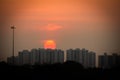 Beautiful view of sunset behind the high rise buildings along the east coast road, chennai, India. Selective focus Royalty Free Stock Photo
