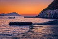 Sunset in fishermen village of Klima, Milos island, Greece. Single adult enjoy sunset view on pier of small fishermen Royalty Free Stock Photo