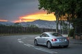 Beautiful view of a sunset from the mountain road and Audi TT driving on the road