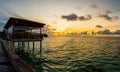 Beautiful view of a sunset over the water villas resort in the Maldives Royalty Free Stock Photo