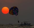 Beautiful view of sunset and parasailing at Colva Beach, Goa