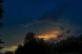 Beautiful view of sunset storm cloud formation enlightened with last yellow sunbeams and visible blue sky Royalty Free Stock Photo