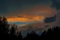 Beautiful view of sunset storm cloud formation enlightened with last yellow sunbeams and visible blue sky Royalty Free Stock Photo