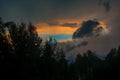 Beautiful view of sunset storm cloud formation enlightened with last yellow sunbeams and visible blue sky Royalty Free Stock Photo