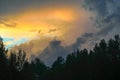 Beautiful view of sunset storm cloud formation enlightened with last yellow sunbeams and visible blue sky Royalty Free Stock Photo