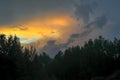 Beautiful view of sunset storm cloud formation enlightened with last yellow sunbeams and visible blue sky Royalty Free Stock Photo