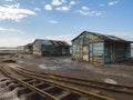 Beautiful view of a three small old wood houses on the side of old rusty railway road