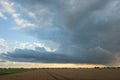 Dramatic looking storm cloud over the dutch countryside at dusk