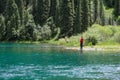 Beautiful view to Kolsai lake with fisherman on mountains background.