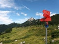 A view up to the mountain with a red signpost Royalty Free Stock Photo