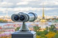 Beautiful view to spires of Admiralty and Peter-Pavel`s Fortress from Isaac cathedral in Binoculars, Saint Petersburg, Russia. Royalty Free Stock Photo