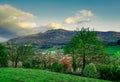 Beautiful view from top of hill. Village in valley. Tree in early spring with blue sky and white clouds. Sunshine to rock mountain Royalty Free Stock Photo