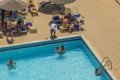 Beautiful view of tourists bathing in hotel`s outdoor swimming pool. Rhodes.