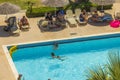 Beautiful view of tourists bathing in hotel`s outdoor swimming pool. Rhodes.