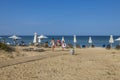 Beautiful view of tourists on sandbeach on blue sky background.