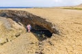 Beautiful view of tourists swimming in natural cave on Atlantic Ocean coastline. Aruba.