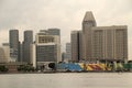 Beautiful view of the towers and buildings in Merlion Park  Singapore under a gray cloudy sky Royalty Free Stock Photo