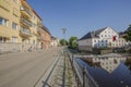 Beautiful view of town street.Yellow and white houses reflecting on water surface. Cloudless blue sky on background. Royalty Free Stock Photo