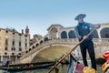 Beautiful view of traditional Gondolas with tourist on famous Canal Grande and Bridge Rialto in Venice, Italy Royalty Free Stock Photo