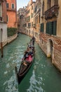 Beautiful view of traditional Gondolas with tourist on famous Canal Grande in Venice, Italy